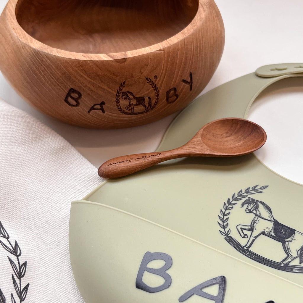 Wooden Bowl with a wooden spoon and a bib